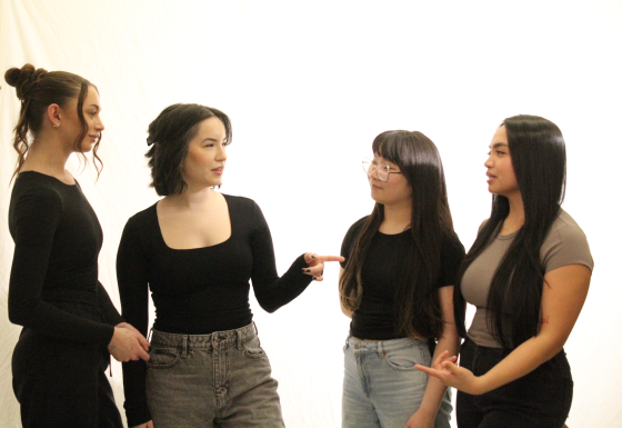 four students having a group discussion